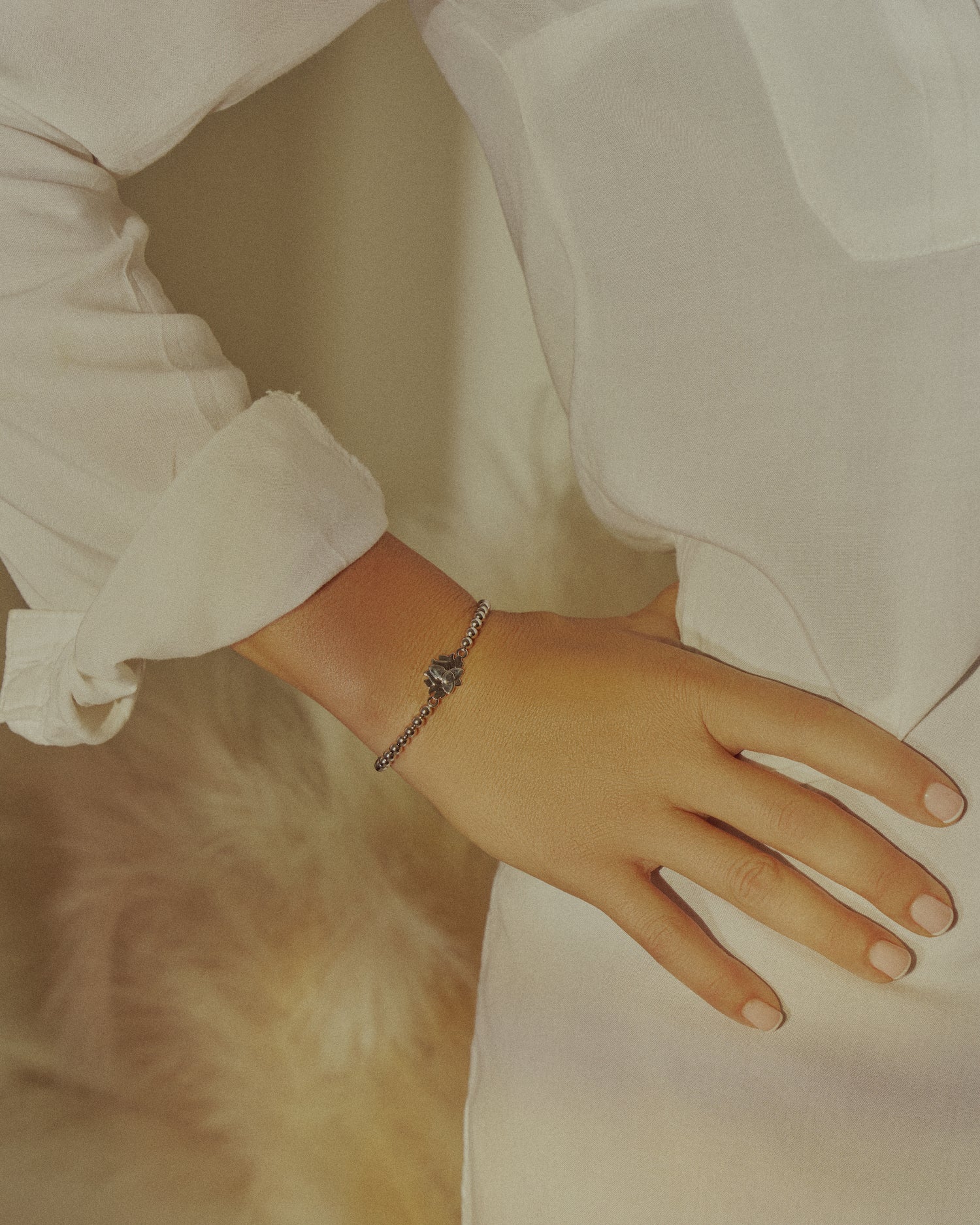 girl wearing gold lotus flower bracelets